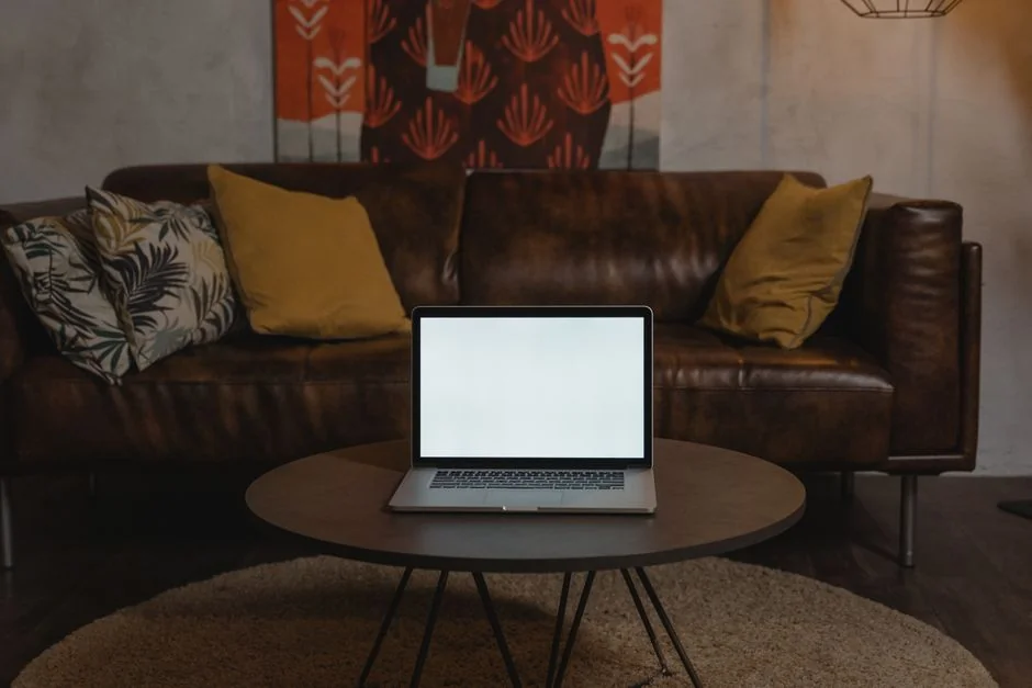 A sleek office desk setup featuring Apple devices: iMac, MacBook, and iPad.